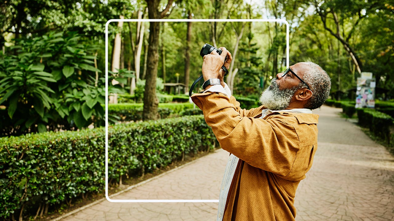 Person holding up a camera.