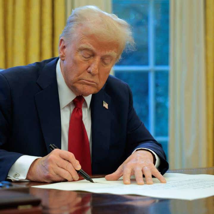 President Donald Trump signs an executive order.