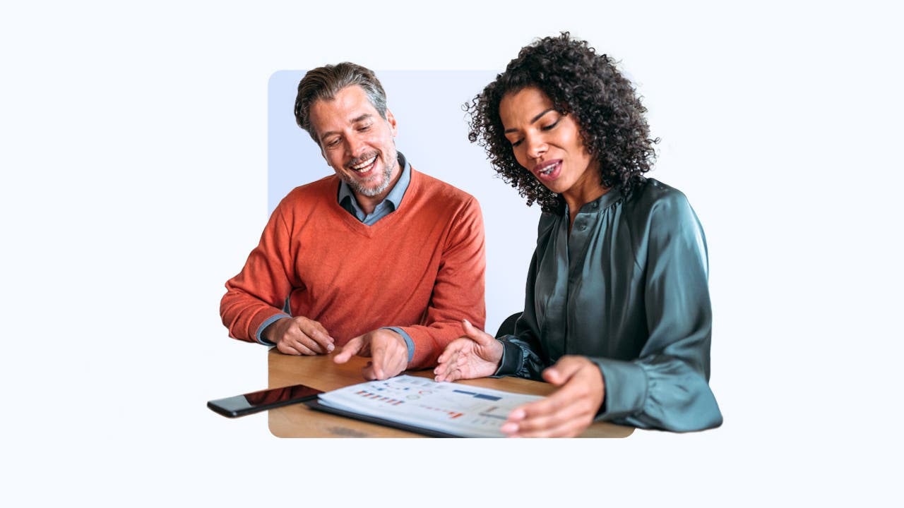Design element of 2 people sitting at a desk going over financial records