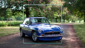 Blue car on rural driveway