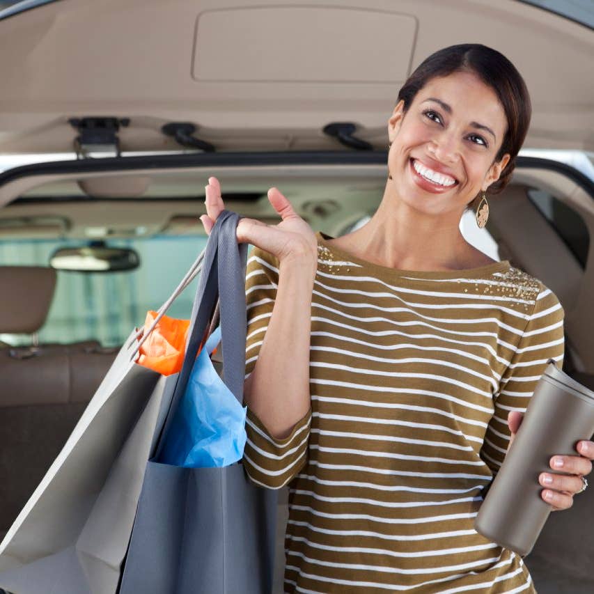 Woman unloading shopping from car