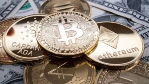 Various crypto tokens stacked on top of cash.