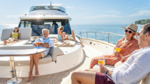 Multigenerational family enjoying cruise on impressive yacht on a sunny day.