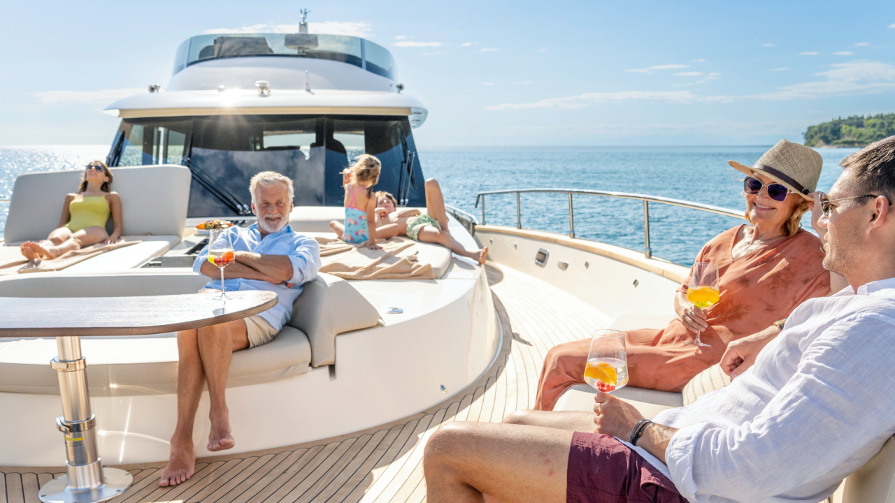 Multigenerational family enjoying cruise on impressive yacht on a sunny day.
