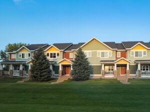 colorful townhouses in peoria, illinois, blue sky and green grass