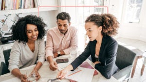 Small business owners looking at application