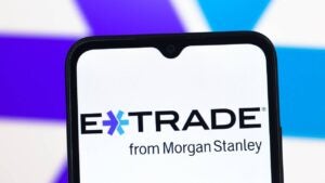 E-Trade logo displayed on a samrtphone.