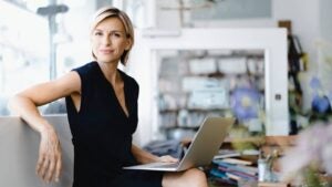 Person with open laptop on their lap.