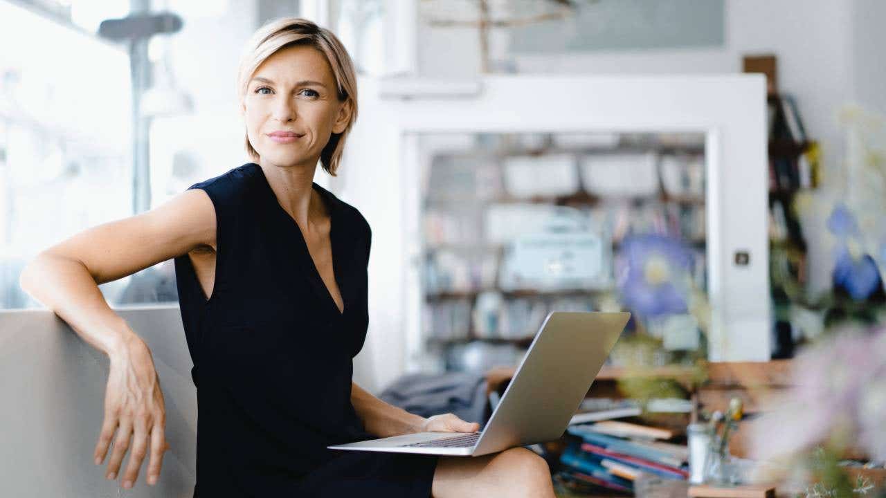 Person with open laptop on their lap.