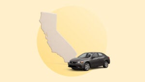 designed image outline of state of california with black sedan in foreground