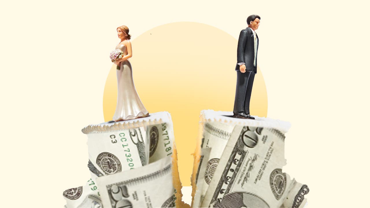 A wedding cake wrapped in money is split in two with a bride on one half and a groom on the other half.