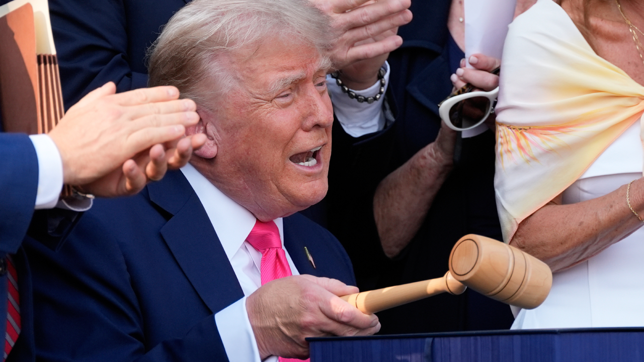 President Donald Trump bangs a gavel after signing the "One, Big Beautiful Bill" Act into law during an Independence Day military family picnic on the South Lawn of the White House on July 04, 2025.