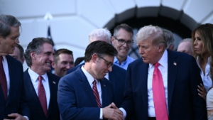 US President Donald Trump shakes hands with House Speaker Mike Johnson after signing the "Big Beautiful Bill Act" at the White House in Washington, DC, on July 4, 2025.