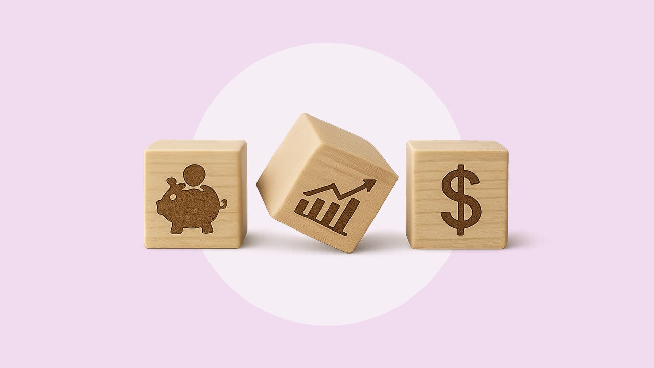 Three light blonde colored wooden blocks in a row with the following painted images: a piggy bank with a coin goin into it's slot, a bar graph and line rising from left to right, and a dollar sign.