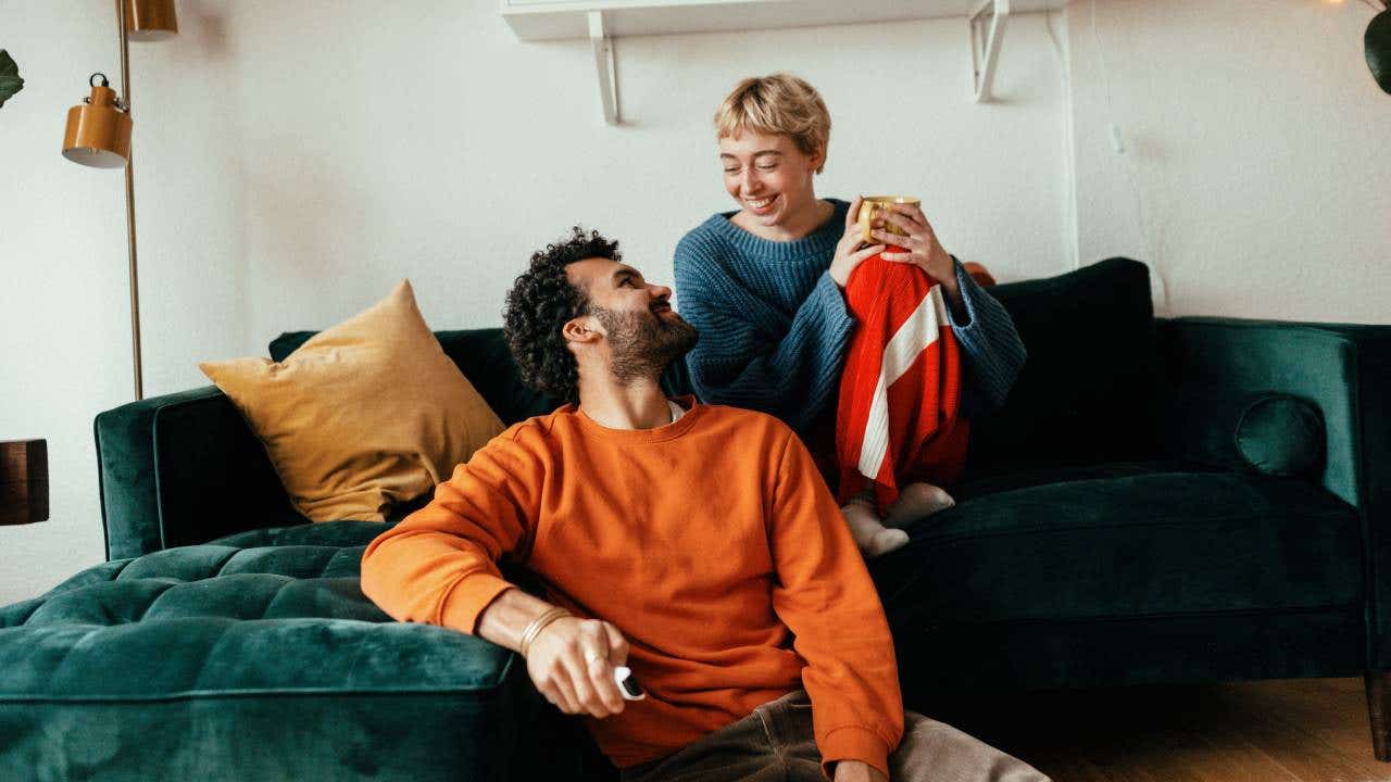 A young couple sits in their apartment.