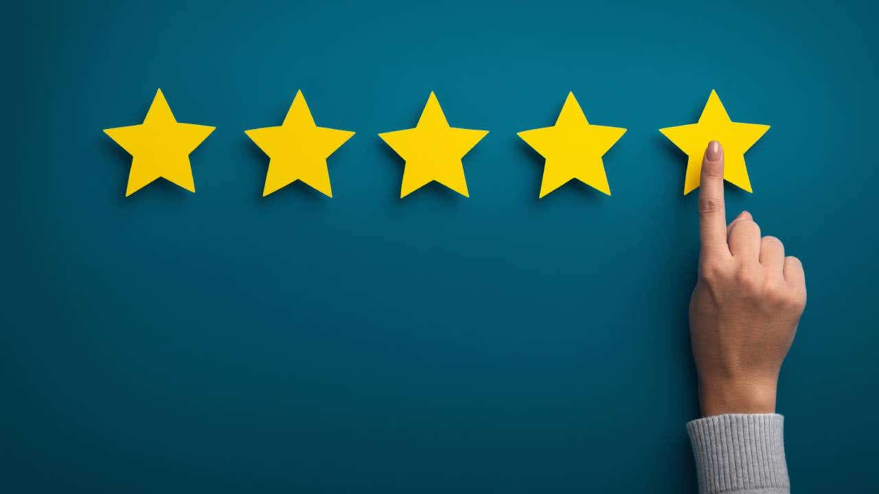 Hand extending to point at a yellow star, suggesting a five-star rating.