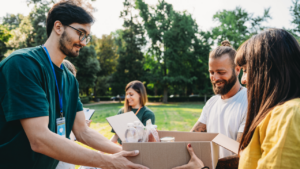 A couple takes a donation box to the food and clothes bank.