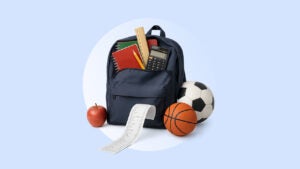 A backpack overflows with school supplies, sports gear and a long receipt