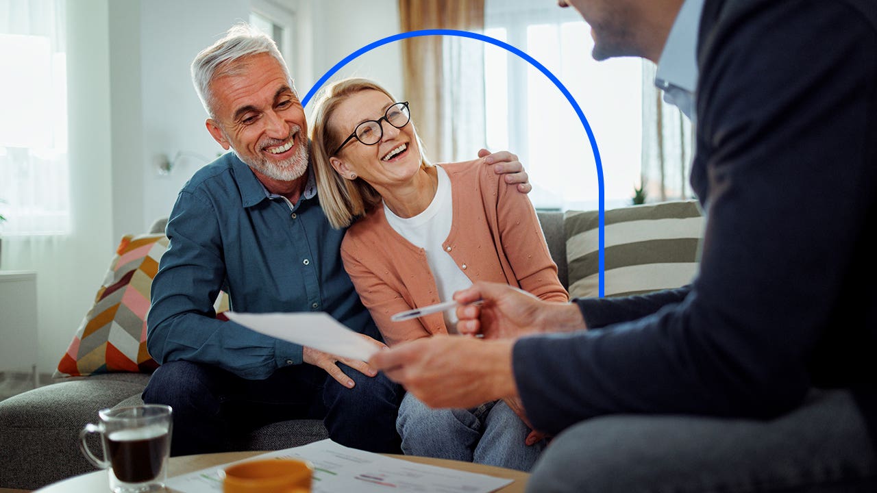 Older couple sitting in their living room with their financial advisor