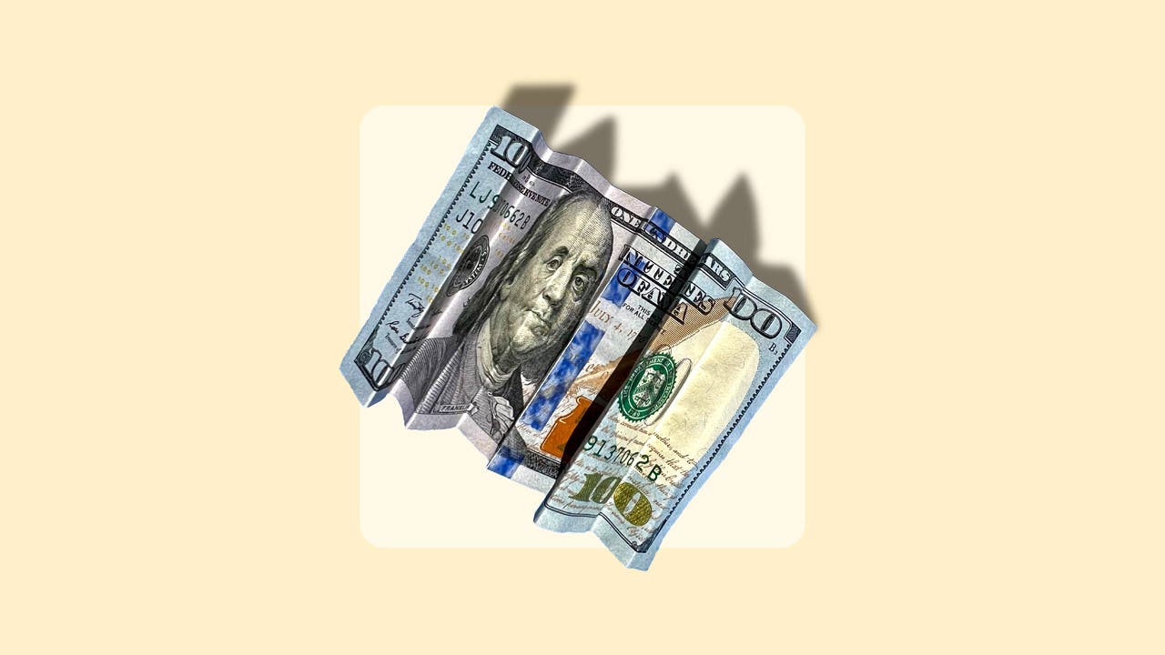 A hundred dollar bill folded accordion style on a yellow background.