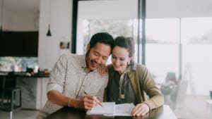 Cheerful couple planning a business budget