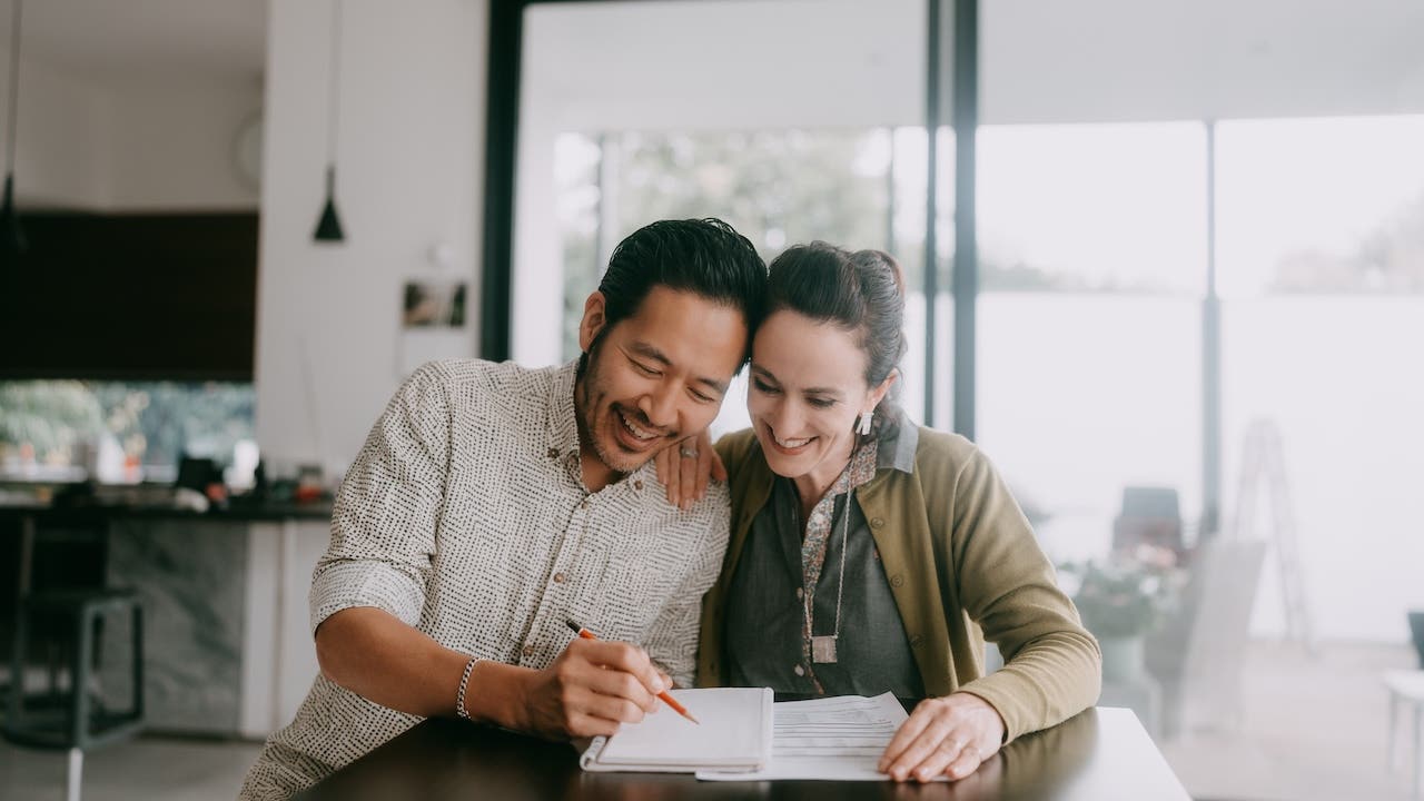 Cheerful couple planning a business budget