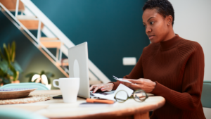 Woman at her laptop calculating finances.