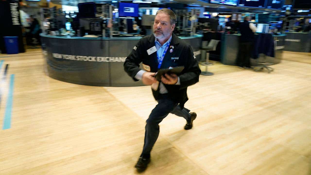A trader runs across the floor of the New York Stock Exchange.