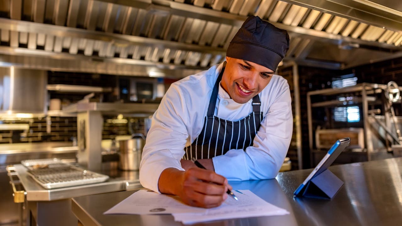 Chef looking over a business plan in a restaurant
