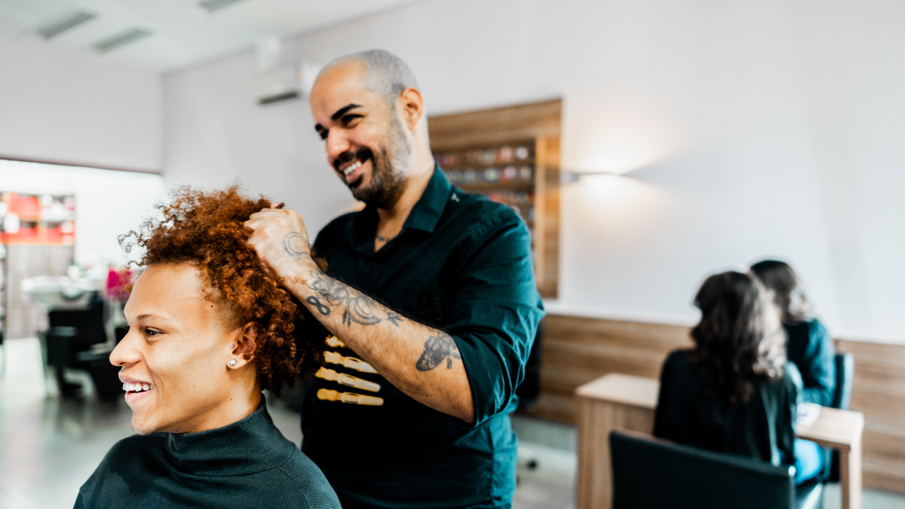 Hairdresser working on a client's hair in a salon.