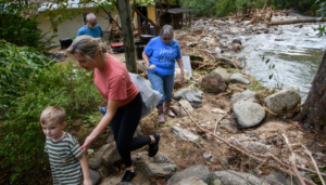 A family removes items from their home in the aftermath of Hurricane Helene on Sept. 30, 2024 in Old Fort, North Carolina.