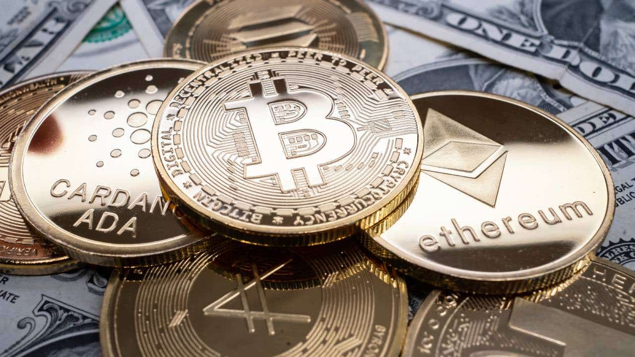 Various cryptocurrency tokens on top of U.S. currency.