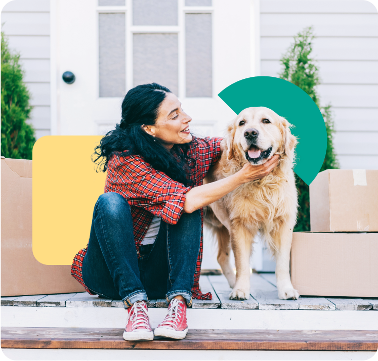 A woman sitting in front of a door, petting her dog A woman sitting in front of a door, petting her dog