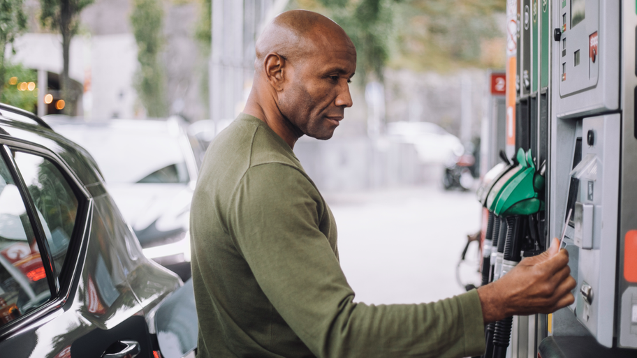 Man at gas pump paying with credit card